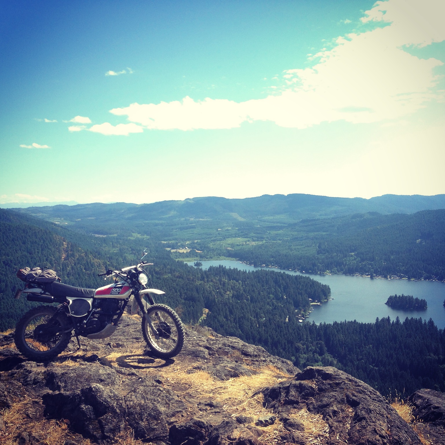 XT500 on mountain cliff overlooking lake